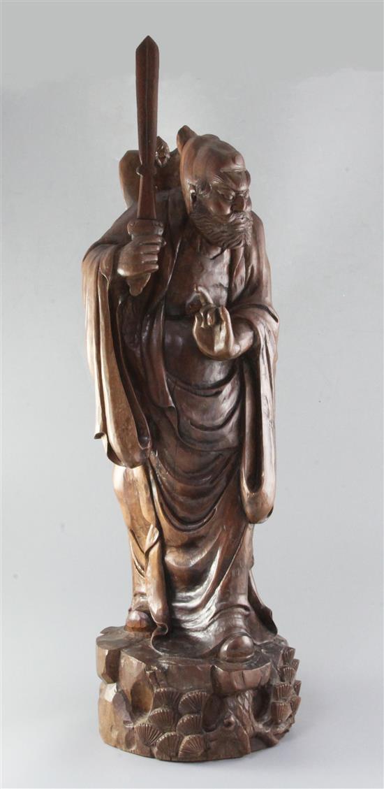 A large Chinese hardwood figure of Lu Dongbin, late 19th/early 20th century, height 71cm, replacement sword blade